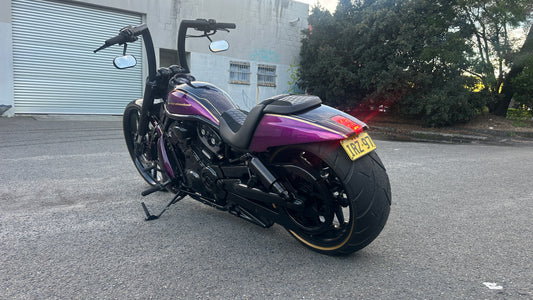 Purple and black Harley Davidson on the street
