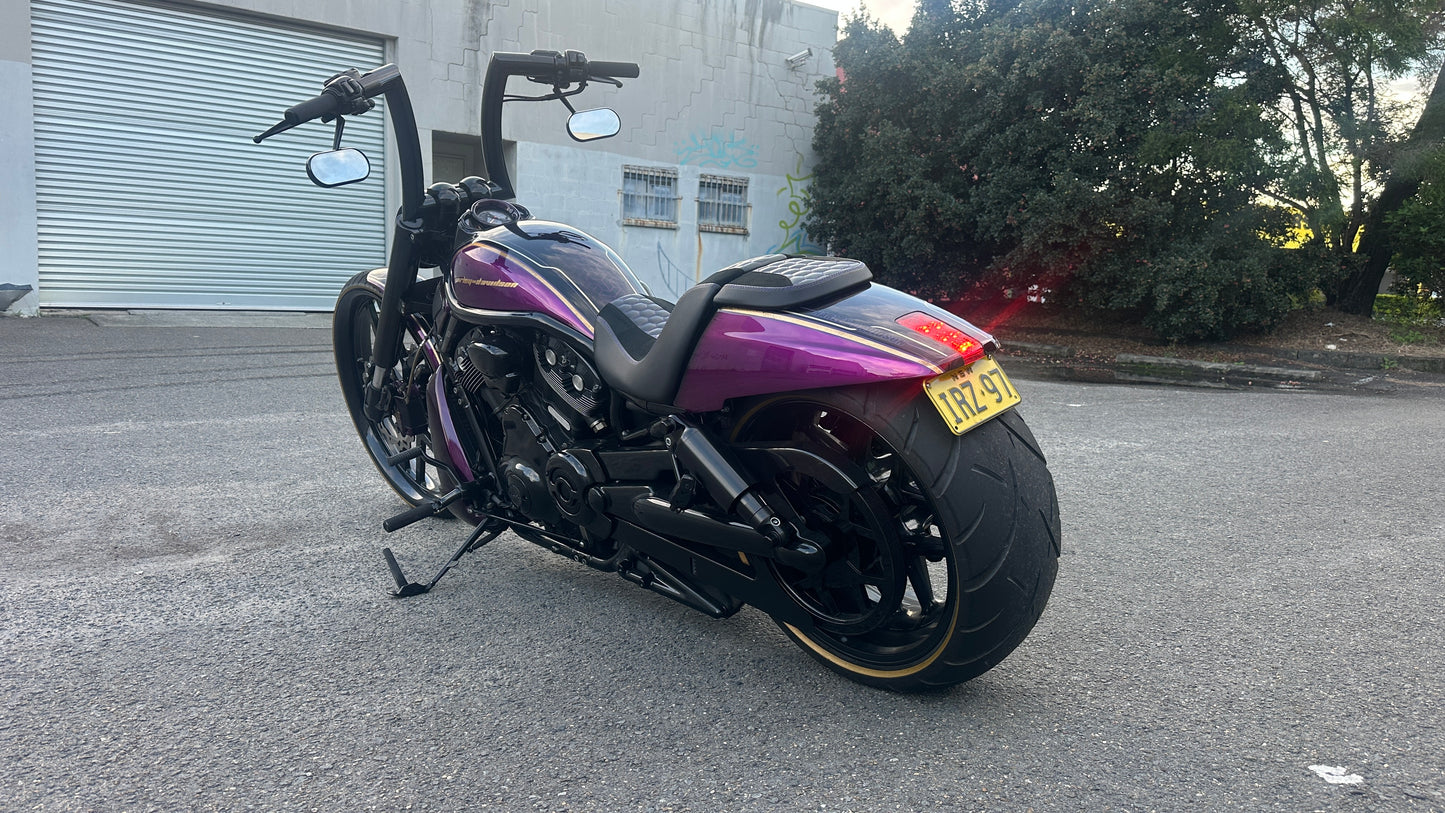Purple and black Harley Davidson on the street